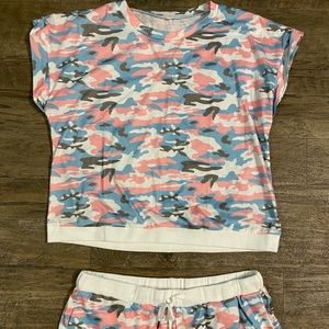 Two piece camo short and shirt outfit.
